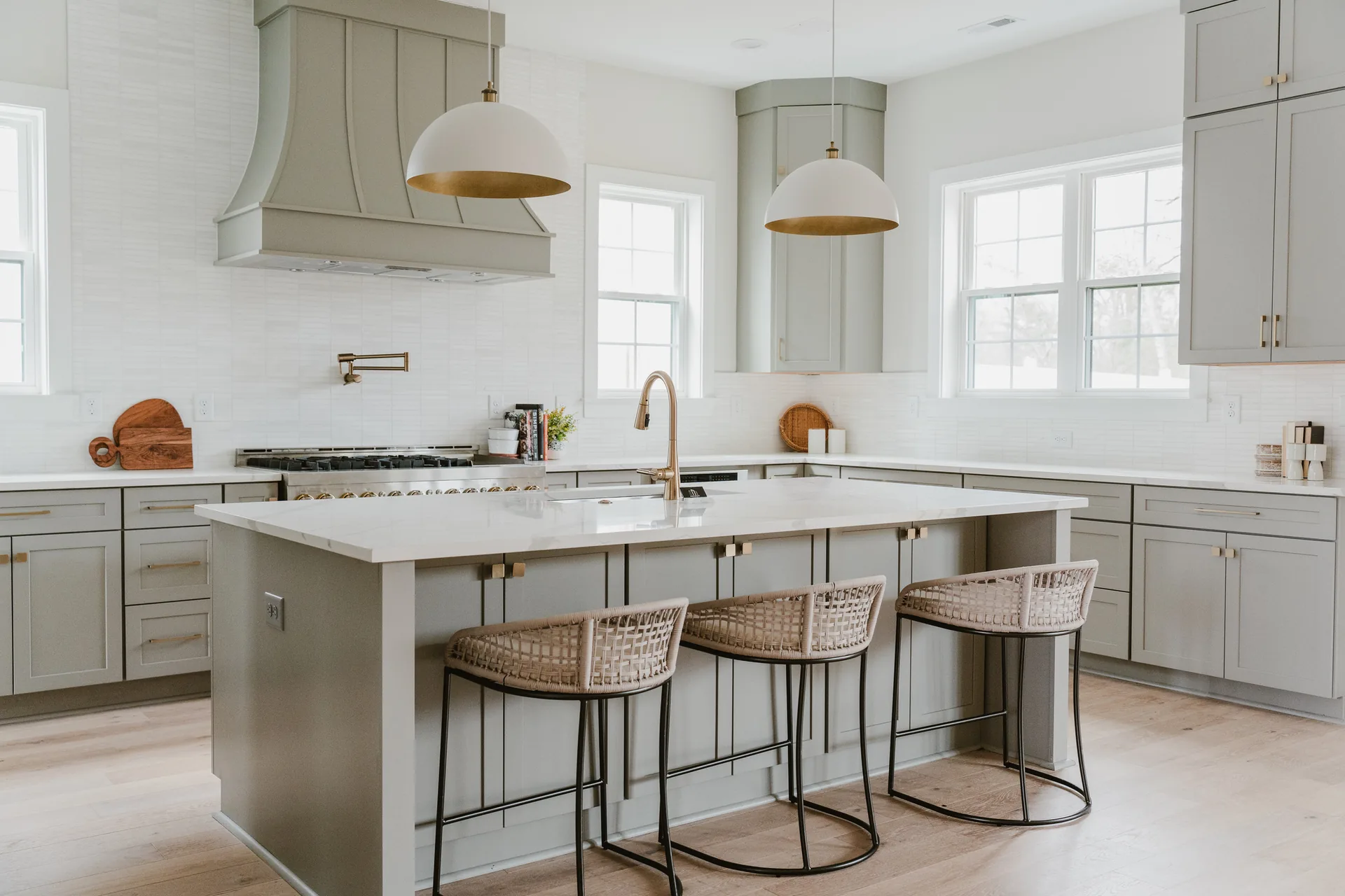 Cabinetry, stone surfaces, and brass fixtures in the completed 571 Lyttleton Dr kitchen.