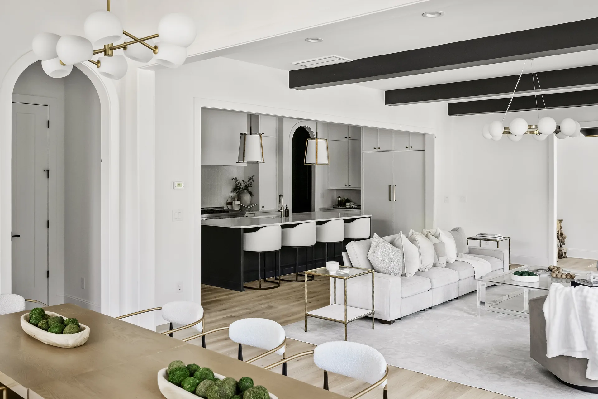 Completed DELLA open-plan living room and kitchen in a refined neutral palette.